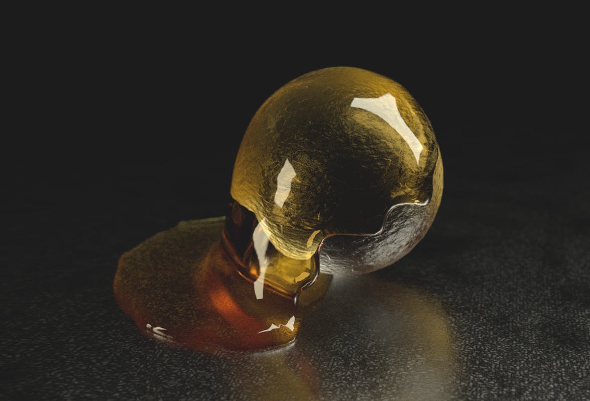 3d render of honey dripping over glassy sphere